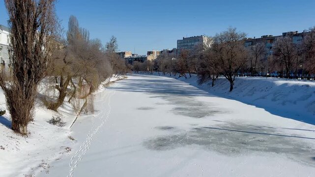 The river is covered with ice in the city center