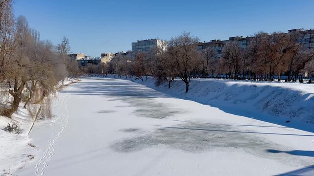 The river is covered with ice in the city center