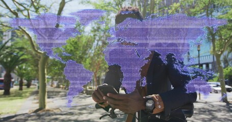 Standing commuter wearing blazer checking smartphone on bike in park, with purple world map overlay