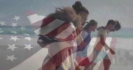 Naklejka premium Walking seven friends wearing beachwear linking arms along sandy beach, with American flag overlay