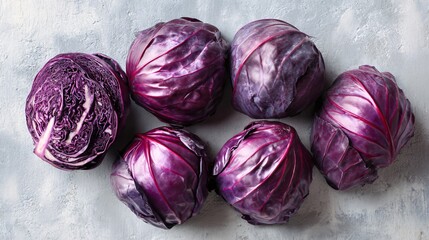 Fototapeta premium Red cabbage arranged for overhead symmetrical layout, pale concrete surface, graphic food design