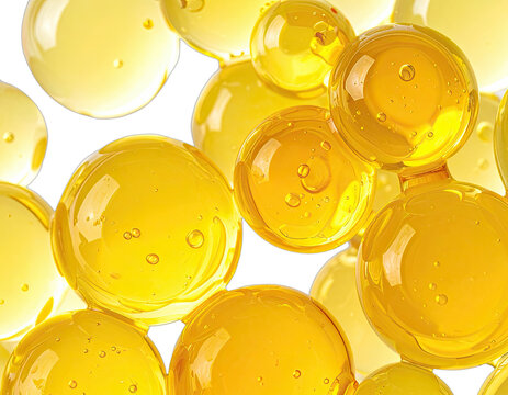 Abstract close-up of vibrant yellow oil or gel spheres against a dark background.