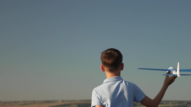 Boy airplane lavender field running happily outdoors dreaming of flying against summer sky.