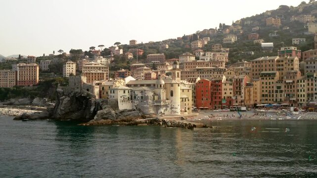 Camogli, Genoa, Italy: aerial view of Camogli on the Ligurian coast of Italy. A sandy beach, colorful houses, and the iconic Basilica di Santa Maria Assunta and Castello della Dragonara