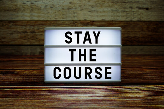 Lightbox with text "Stay The Course" on wooden background