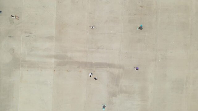 Top down aerial view of people roller skating on park pathway, urban recreation and lifestyle in Mazatlan, Mexico.