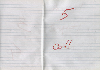 Lined notebook paper background with handwritten word Cool and number five in red pencil. Minimalist textured stationery surface, school notebook page &mdash; highest score