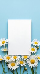 Obraz premium A blank white card centered on a light blue background surrounded by fresh daisies with bright yellow centers.