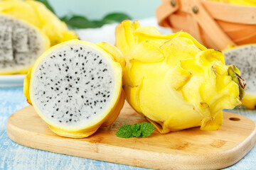 Fresh Yellow Dragon Fruit Cut in Half on Wooden Board © LuongThi