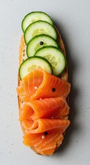 Fresh, vibrant smoked salmon and delicate cucumber slices arranged for a healthy appetizer or light meal. Focus on omega three fats ,seafood ,diet ,pink