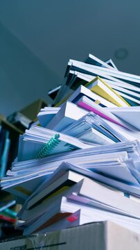 Stop motion sequence of books and business documents stacking up