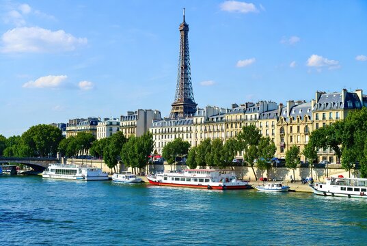 Panoramic view of the Eiffel Tower, Seine River, and Parisian buildings on a clear
