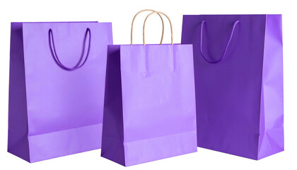 Three lilac paper shopping bags with rope handles, isolated on black