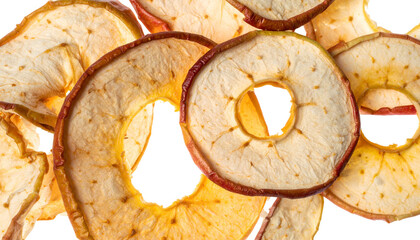 Close-up of dried apple slices, showing textures and colors, stacked on a black background
