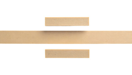 Abstract composition. Three beige rectangular forms in a line against a black backdrop