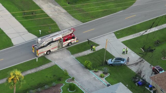 Car crash with first responders helping at accident site on American street. Vehicle collision on road in USA.