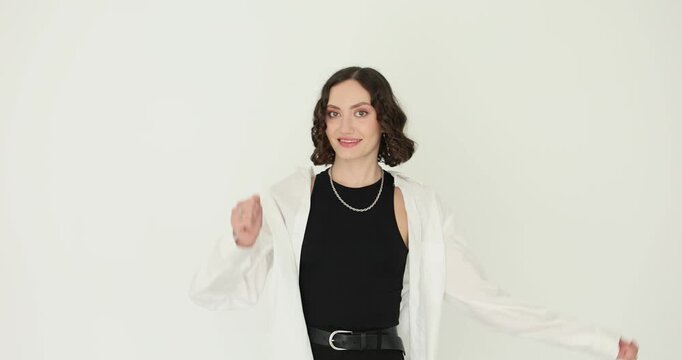 Woman in white shirt hits head gently with fist. Forgetful person realizes mistake while showing playful regretful reaction in studio slow motion
