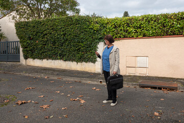 A nurse on call is looking for a patient in a residential area