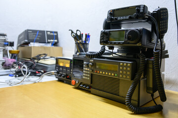Three transmitting stations stacked on top of each other on a workbench.
