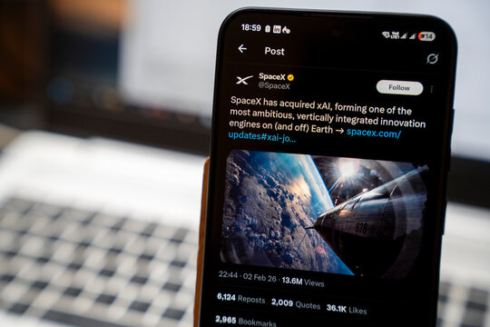 Warsaw, Poland - Feb 3, 2026: A smartphone displaying a SpaceX Twitter post about their acquisition of xAI, showcasing innovative technology advancements in space exploration.