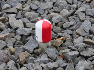 white red metallic cover between the train tracks