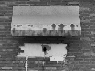 metallic cover serving as a weather strip, black and white