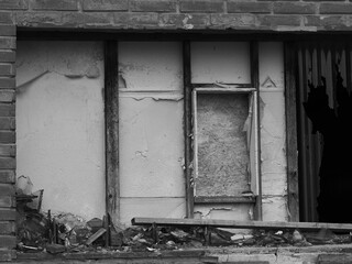 monochrome image of a dilapidated house wall