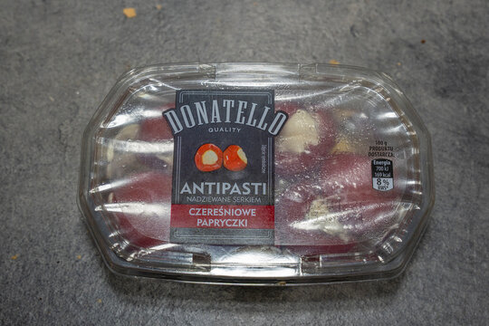 Poland - Feb 1, 2026: A transparent packaging containing Donatello brand antipasti with cheese-stuffed cherry peppers displayed on a textured surface.