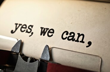 Fototapeta premium Vintage typewriter prints yes, we can, message on old paper. Retro text detail captures a classic, motivational phrase with copy space for design.