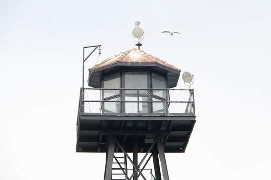 Prison guard tower isolated against pale sky