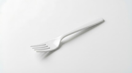 White plastic fork isolated against clean light background for stock images