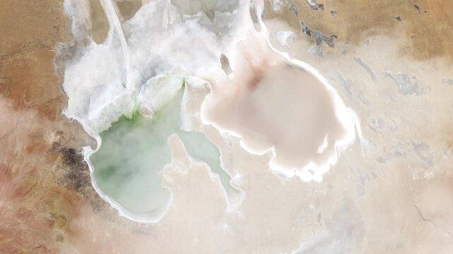Rotating flying over Lake Eyre satellite view with passing clouds based on Nasa imagery