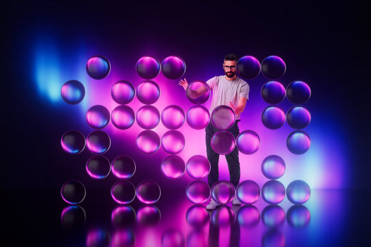 Man interacting with floating purple 3D spheres in studio scene