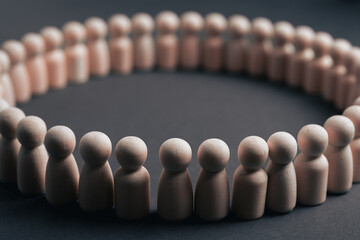 Wooden Peg Dolls in a Circle Representing a Unified and Inclusive Workforce Culture and Teamwork