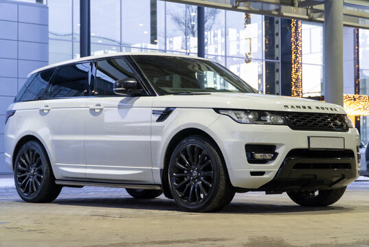 White Land Rover Range Rover Sport SVR II sports SUV car parked at the city street. White SUV car Land Rover Range Rover Sport HSE British car manufacturer on parking lot. SVR.