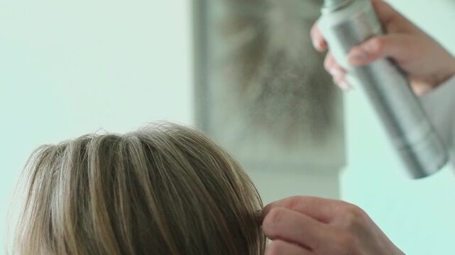 A young girl is getting her hair done