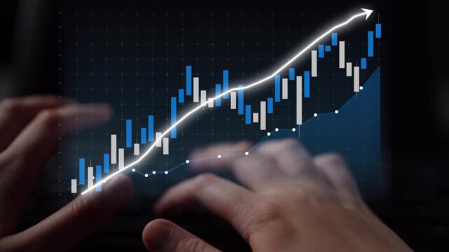 A close-up view of hands interacting with a digital screen displaying a financial graph representing a positive trend in the stock market and trading data. Copula
