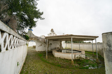 Stone fountain in Arraiolos, Portugal, showcasing traditional architecture and historic charm in a picturesque village setting.