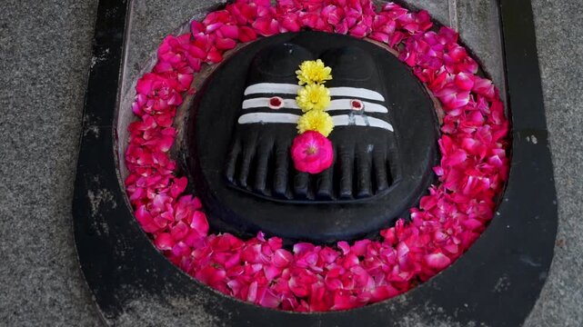 India, Tamil Nadu, 11-02-2025. Footprints of Master Paduka, a sacred symbol of devotion, humility and blessing in Babaji Temple. Tilt 4K