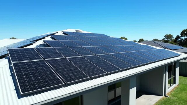Solar panels on roof under clear blue sky, clean energy renewable source. Environmentally friendly technology, sustainable resources, alternative power.