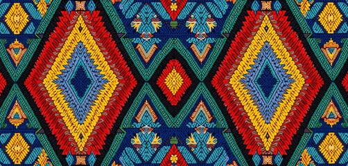 Fototapeta premium Colorful Ndebele geometric patterns fill frame. Vibrant tribal textile art from South Africa displays intricate diamond shapes and zigzags. Authentic heritage design.