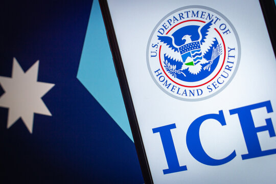 Quito, ECUADOR - Jan 25 2026 : Smartphone screen displaying the U.S. Department of Homeland Security and ICE logos with Minnesota flag background.