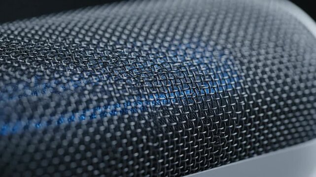 Close-up of microphone mesh pattern, macro detail of technology and sound.