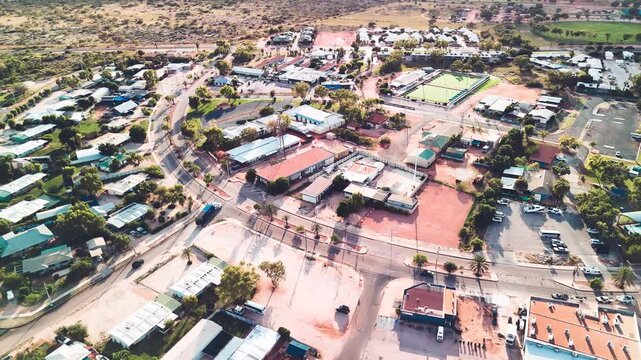 Birds eye perspective showcasing Exmouth neighborhood houses coastal township harbor turquoise ocean backdrop Australia