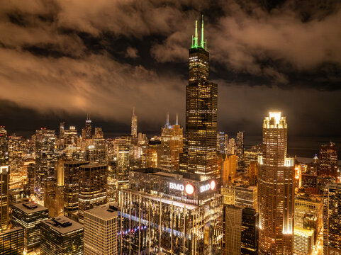  Aerial view of the Willis Tower and BMO Tower in the Chicago skyline at sunset This high-altitude aerial perspective captures a stunning sunset over downtown Chicago, focusing on the landmark Willis 