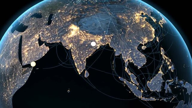Globe centered on Asia at night with city lights and flight paths.