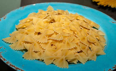 bow tie pasta on blue plate background
