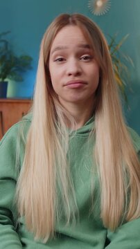 Displeased upset woman reacting to unpleasant awful idea, dissatisfied with bad quality, wave hand, shake head No, dismiss idea, dont like proposal. Young Caucasian lady at home apartment room on sofa