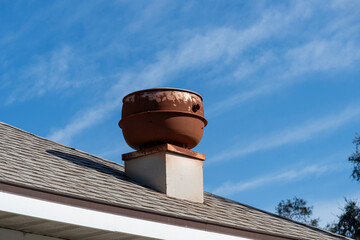 An old restaurant vent on a shingle roof