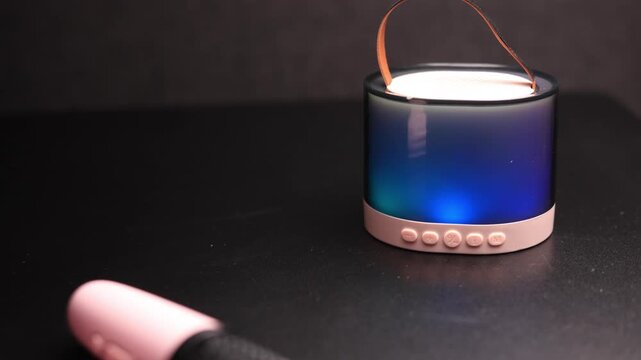 Portable Bluetooth speaker with colorful LED lights and a convenient carrying strap
